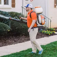 TruMosquito tech spraying home exterior shrubs